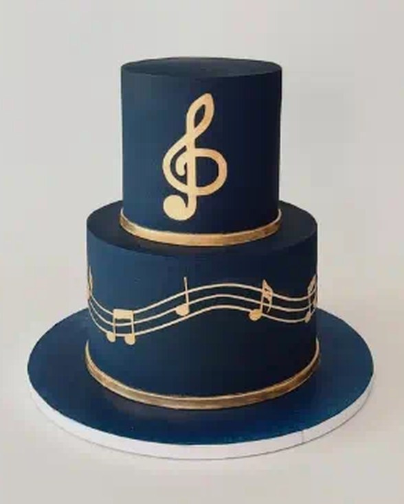Two-tier navy cake with gold treble clef and music notes